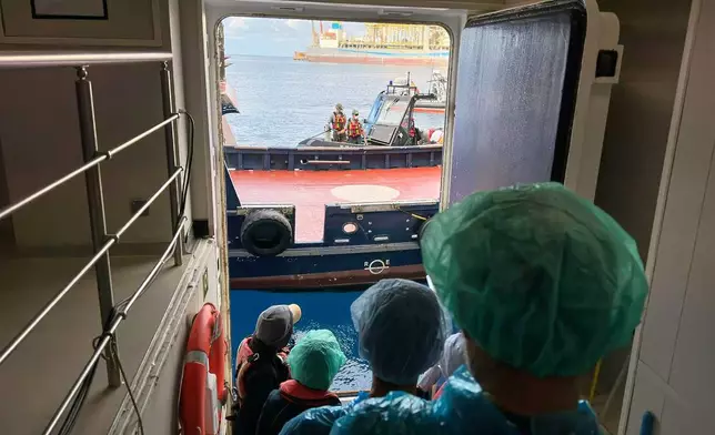 Passengers are being disembarked from the hantavirus-stricken cruise ship MV Hondius at the port of Granadilla in Tenerife, Canary Islands, Spain, Sunday, May 10, 2026. (AP Photo)