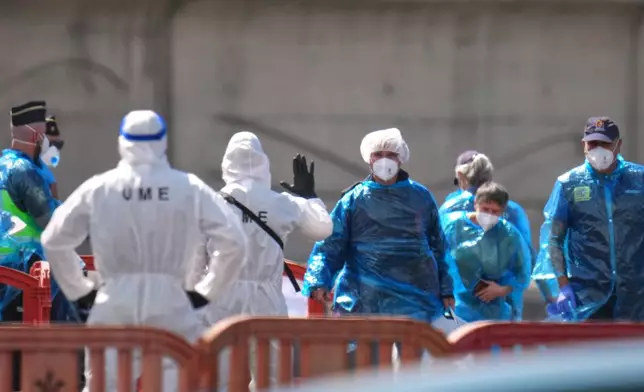 Passengers are disembarked from the hantavirus-stricken cruise ship MV Hondius at the port of Granadilla in Tenerife, Canary Islands, Spain, Sunday, May 10, 2026. (AP Photo/Manu Fernandez)