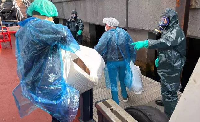 Passengers are disembarked from the hantavirus-stricken cruise ship MV Hondius at the port of Granadilla in Tenerife, Canary Islands, Spain, Sunday, May 10, 2026. (AP Photo)