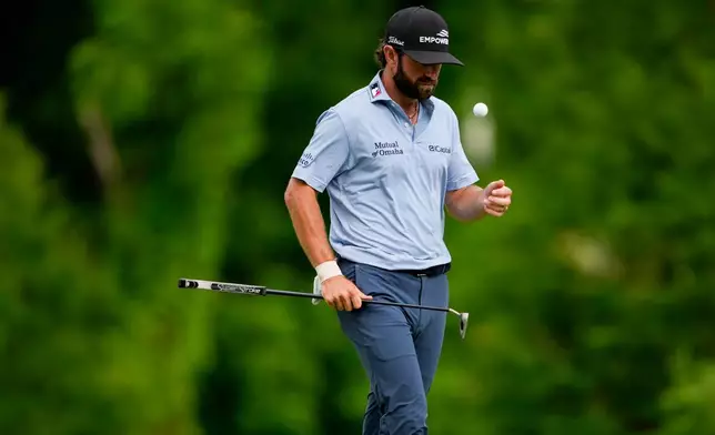 Cameron Young flips his golf ball on the 12th green during third round of the Truist Championship golf tournament at the Quail Hollow Club, Saturday, May 9, 2026, in Charlotte, N.C. (AP Photo/Chris Carlson)