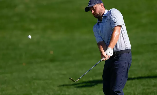 Alex Fitzpatrick, of England, chips on the 15th hole during the final round of the Truist Championship golf tournament at the Quail Hollow Club, Sunday, May 10, 2026, in Charlotte, N.C. (AP Photo/Chris Carlson)