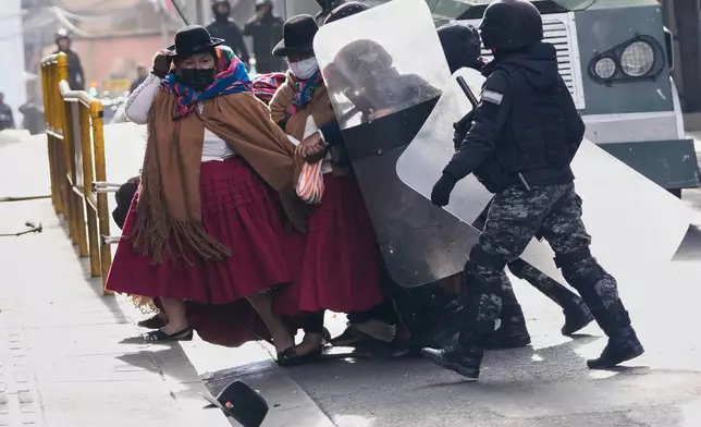 Police approach anti-government protesters in La Paz, Bolivia, Monday, May 18, 2026. (AP Photo/Juan Karita)