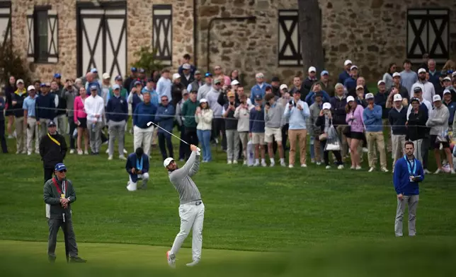 Scottie Scheffler practices on the 18th hole before the PGA Championship golf tournament at the Aronimink Golf Club Monday, May 11, 2026, in Newtown Square, Pa. (AP Photo/Matt Slocum)