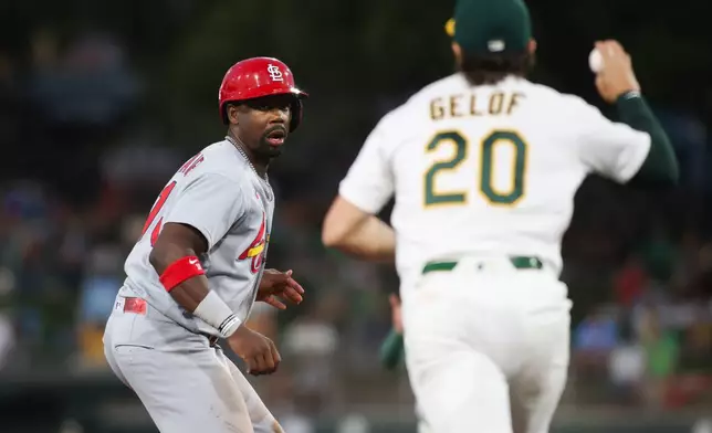 St. Louis Cardinals' Jordan Walker, left, is caught in a run down during the fifth inning of a baseball game against the Athletics Tuesday, May 12, 2026, in West Sacramento, Calif. (AP Photo/Scott Marshall)