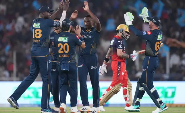 Gujarat Titans' Kagiso Rabada celebrate with teammates the wicket of Royal Challengers Bengaluru's Virat Kohli during the Indian Premier League cricket match between Gujarat Titans and Royal Challengers Bengaluru in Ahmedabad, India, Thursday, April 30, 2026. (AP Photo/Ajit Solanki)
