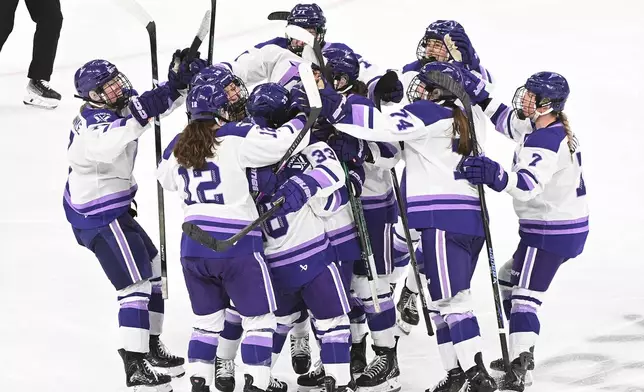 Minnesota Frost's Jincy Roese (33) is mobbed by teammates after scoring during the overtime of an PWHL playoff hockey game against the Montreal Victoire in Laval, Que., Saturday, May 2, 2026. (Graham Hughes/The Canadian Press via AP)