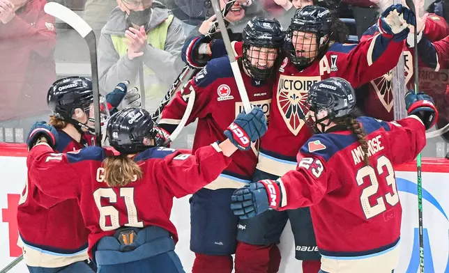 Montreal Victoire's Laura Stacey (7) celebrates with teammates after scoring against the Minnesota Frost during the third period of a PWHL playoff hockey game in Laval, Quebec Saturday, May 2, 2026. (Graham Hughes/The Canadian Press via AP)