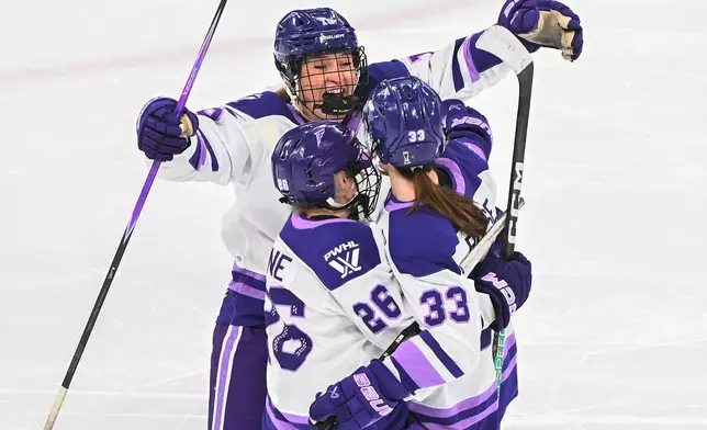 Minnesota Frost's Jincy Roese celebrates with teammates Brooke Becker (15) and Kendall Coyne Schofield (26) after scoring the game winning goal against the Montreal Victoire during overtime in a PWHL playoff hockey game in Laval, Quebec, Saturday, May 2, 2026. (Graham Hughes/The Canadian Press via AP)
