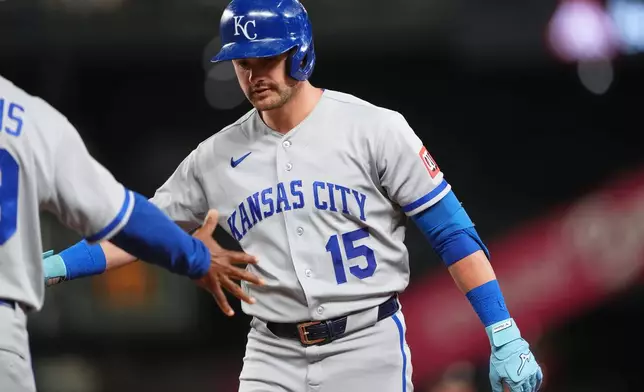 Kansas City Royals' Lane Thomas celebrates hitting an RBI single against the Seattle Mariners during the eighth inning of a baseball game, Friday, May 1, 2026, in Seattle. (AP Photo/Lindsey Wasson)