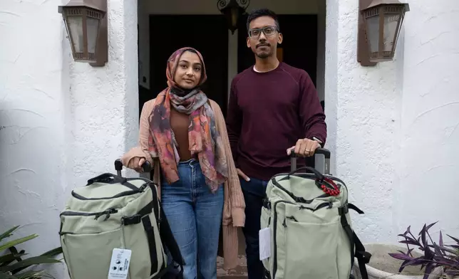 Samiha Matin, left, and Faisal Rashid pose for a portrait with their baggage for the annual Hajj pilgrimage in Mecca, Saudi Arabia, at their home in Pasadena, Calif, Sunday, May 17, 2026. (AP Photo/Ryan Sun)