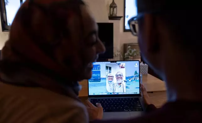 Samiha Matin, left, laughs with her husband Faisal Rashid as they video chat with Samiha Matin's parents, Mohammed and Nasima Matin, Sunday, May 17, 2026, in Pasadena, Calif. (AP Photo/Ryan Sun)