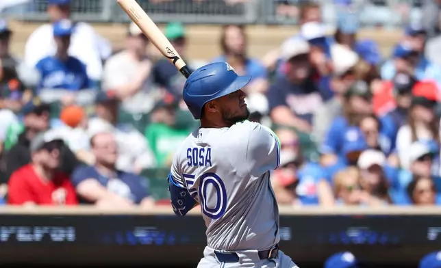 Toronto Blue Jays' Lenyn Sosa hits a solo home run against the Minnesota Twins during the second inning of a baseball game, Saturday, May 2, 2026, in Minneapolis. (AP Photo/Matt Krohn)