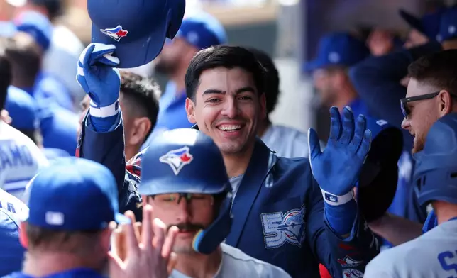 Toronto Blue Jays' Brandon Valenzuela, center, celebrates after his three-run home run against the Minnesota Twins during the eighth inning of a baseball game, Saturday, May 2, 2026, in Minneapolis. (AP Photo/Matt Krohn)