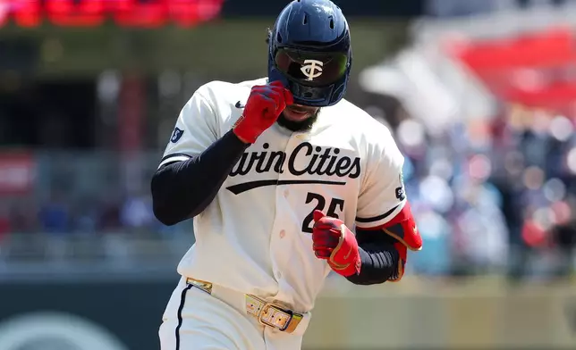 Minnesota Twins' Byron Buxton celebrates his solo home run as he runs the bases during the first inning of a baseball game against the Toronto Blue Jays, Saturday, May 2, 2026, in Minneapolis. (AP Photo/Matt Krohn)