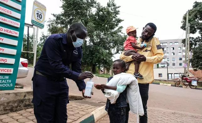 A girl sanitises her hands in front of Kibuli Muslim Hospital in Kampala, Uganda, Saturday, May 16, 2026. (AP Photo/ Hajarah Nalwadda)