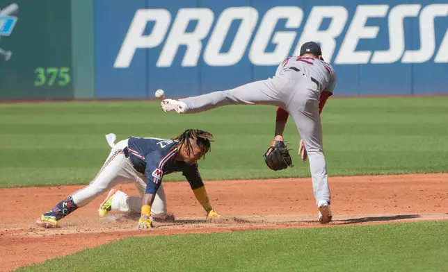 Cleveland Guardians' Jose Ramirez, left, is safe at second base as Boston Red Sox' Isiah Kiner-Falefa misses the throw during the first inning of a baseball game, Saturday, May 30, 2026, in Cleveland. (AP Photo/Phil Long)