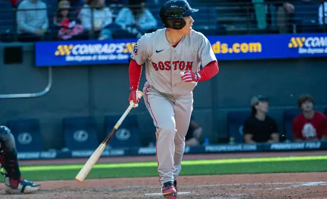 Boston Red Sox' Masataka Yoshida watches his fly out off Clveland Guardians relief pitcher Codi Heuer during the seventh inning of a baseball game, Saturday, May 30, 2026, in Cleveland. (AP Photo/Phil Long)