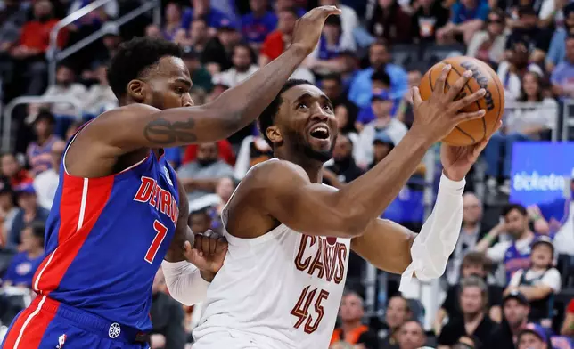 Cleveland Cavaliers guard Donovan Mitchell (45) drives past Detroit Pistons forward Paul Reed (7) for a shot during the second half of Game 7 in a second-round NBA basketball playoffs series, Sunday, May 17, 2026, in Detroit. (AP Photo/Duane Burleson)