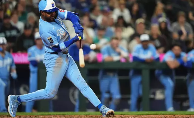 Kansas City Royals' Maikel Garcia hits an RBI sacrifice fly against the Seattle Mariners during the 10th inning of a baseball game, Saturday, May 2, 2026, in Seattle. (AP Photo/Lindsey Wasson)