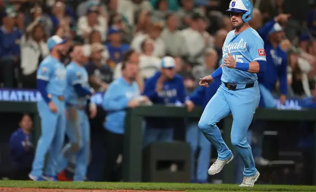 Kansas City Royals' Lane Thomas scores on an RBI single from Jac Caglianone, who would advance to third base on a fielding error by Seattle Mariners center fielder Julio Rodríguez, during the ninth inning of a baseball game, Saturday, May 2, 2026, in Seattle. (AP Photo/Lindsey Wasson)