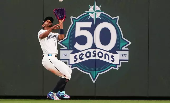 Seattle Mariners center fielder Julio Rodríguez catches a fly ball from Kansas City Royals' Carter Jensen during the sixth inning of a baseball game, Saturday, May 2, 2026, in Seattle. (AP Photo/Lindsey Wasson)