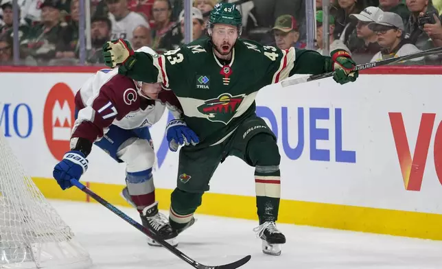 Minnesota Wild defenseman Quinn Hughes (43) looks toward a referee while defended by Colorado Avalanche center Parker Kelly (17) during the second period of Game 3 of an NHL Stanley Cup hockey second-round playoff series Saturday, May 9, 2026, in St. Paul, Minn. (AP Photo/Abbie Parr)