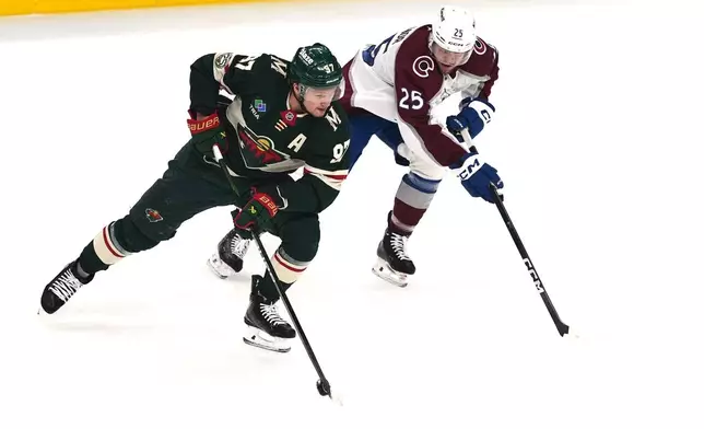Minnesota Wild left wing Kirill Kaprizov (97) skates with the puck as Colorado Avalanche right wing Logan O'Connor (25) defends during the first period of Game 3 of an NHL Stanley Cup hockey second-round playoff series Saturday, May 9, 2026, in St. Paul, Minn. (AP Photo/Abbie Parr)