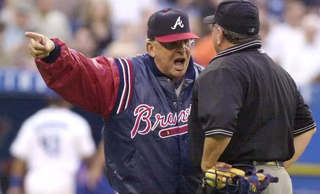 FILE - Atlanta Braves manager Bobby Cox, left, argues with home plate umpire Rick Reed during the fourth inning of interleague play against the Toronto Blue Jays, in Toronto, June 13, 2001. (Aaron Harris/The Canadian Press via AP, File)