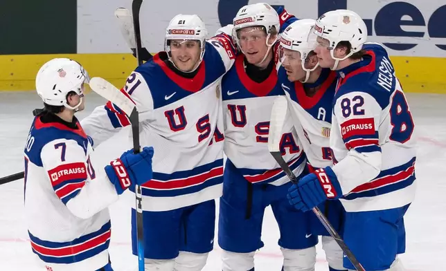 USA's Matthew Tkachuk, second right, celebrates after scoring his side's first goal during the 2026 IIHF Men's Ice Hockey World Championship preliminary round group A match between Latvia and the United States in Zurich, Switzerland, Saturday, May 23, 2026. (Andreas Becker/Keystone via AP)