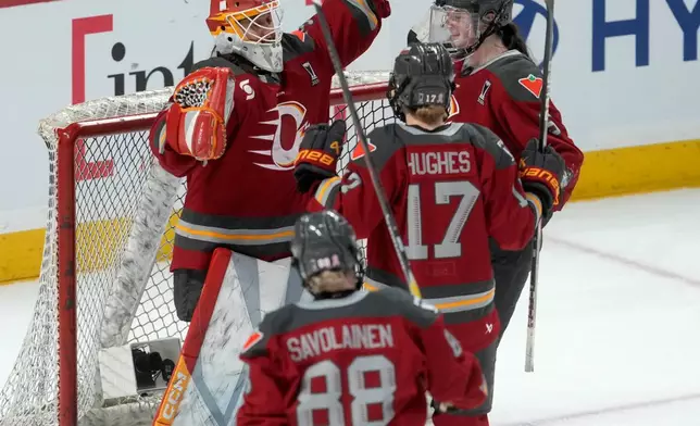 Ottawa Charge goalie Gwyneth Philips, left, celebrates with teammates after defeating the Montreal Victoire in Game 3 of the PWHL Walter Cup finals hockey series in Ottawa, Ontario, Monday May 18, 2026. (Adrian Wyld/The Canadian Press via AP)