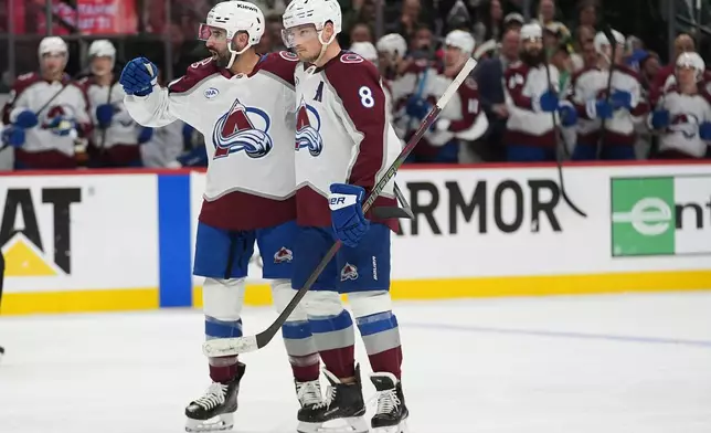 Colorado Avalanche center Nazem Kadri (91), left, celebrates with defenseman Cale Makar (8) after scoring a goal during the second period of Game 4 in an NHL Stanley Cup hockey second-round playoff series against the Minnesota Wild Monday, May 11, 2026, in St. Paul, Minn. (AP Photo/Abbie Parr)