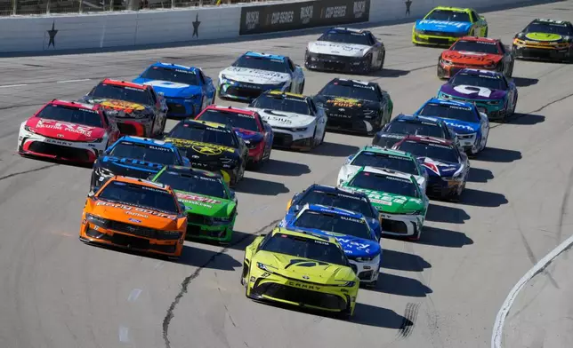 The NASCAR Cup Series field drives into Turn 1 during an auto race in Fort Worth, Texas, Sunday, May 3, 2026. (AP Photo/Larry Papke)