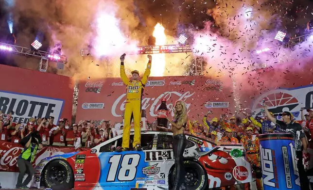 FILE - Kyle Busch celebrates after winning the NASCAR Cup Series auto race at Charlotte Motor Speedway in Charlotte, N.C., Sunday, May 27, 2018. (AP Photo/Chuck Burton, File)