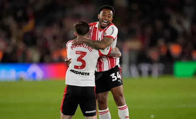 Southampton's Welington, right, and Ryan Manning celebrate at the final whistle in the EFL Championship play off semifinal soccer game between Southampton and Middlesbrough, Tuesday, May 12, 2026, in, Southampton, England. (Andrew Matthews/PA via AP)