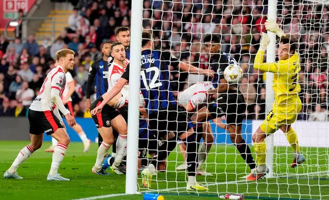 Southampton's Ross Stewart, center partially obscured, scores their first goal of the game during the EFL Championship play off semifinal soccer game between Southampton and Middlesbrough, Tuesday, May 12, 2026, in, Southampton, England. (Andrew Matthews/PA via AP)