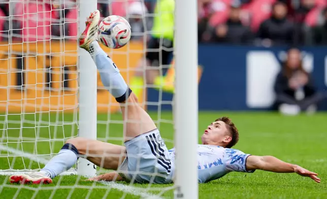 San Jose Earthquakes defender Reid Roberts (18) slides in to save a goal by the Toronto FC during the second half of an MLS soccer game in Toronto, Saturday, May 2, 2026. (Frank Gunn/The Canadian Press via AP)