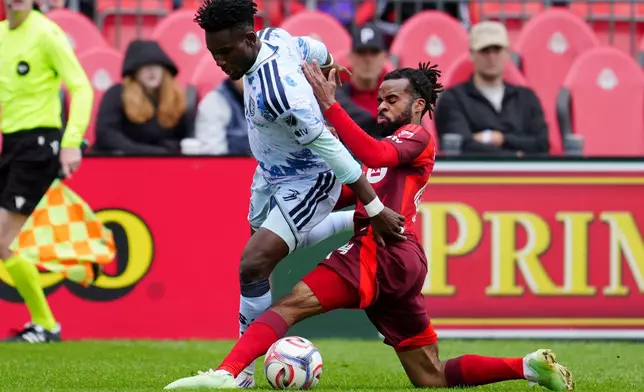Toronto FC defender Raheem Edwards, right, tackles San Jose Earthquakes forward Ousseni Bouda (7) during the first half of an MLS soccer game in Toronto, Saturday, May 2, 2026. (Frank Gunn/The Canadian Press via AP)
