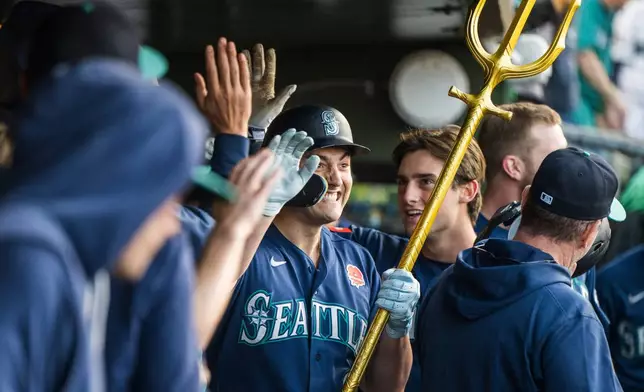 Seattle Mariners' Dominic Canzone, center, celebrates after hitting a home run during the third inning of a baseball game against the Athletics in West Sacramento, Calif., Monday, May 25, 2026. (AP Photo/Nic Coury) CORRECTION: Corrects to Dominic Canzone not Cole Young.