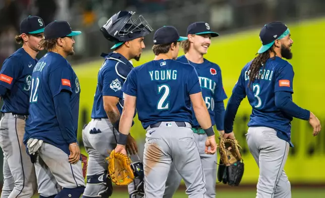 The Seattle Mariners celebrate after winning a baseball game against the Athletics in West Sacramento, Calif., Monday, May 25, 2026. (AP Photo/Nic Coury)