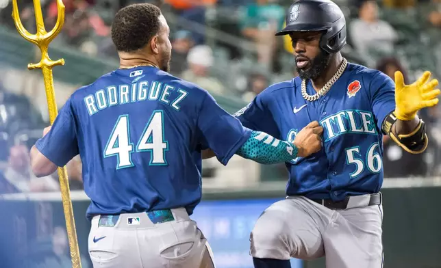 Seattle Mariners' Randy Arozarena (56) celebrates with Julio Rodríguez (44) after Arozarena hit a home run during the ninth inning of a baseball game against the Athletics in West Sacramento, Calif., Monday, May 25, 2026. (AP Photo/Nic Coury)