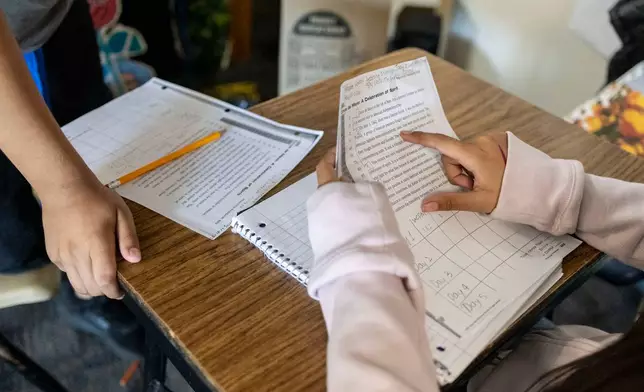 Sixth graders read a passage and give constructive feedback to their partners during Nancy Barajas' class at Fairview Elementary School on Wednesday, May 6, 2026, in Modesto, Calif. (AP Photo/Annie Barker)
