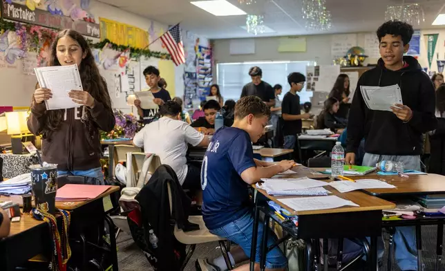 Sixth graders read a passage and give constructive feedback to their partners during Nancy Barajas' class at Fairview Elementary School on Wednesday, May 6, 2026, in Modesto, Calif. (AP Photo/Annie Barker)
