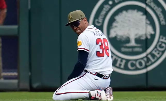 Atlanta Braves right fielder José Azócar (38) celebrates a catch off the bat of Boston Red Sox catcher Carlos Narváez in the third inning of a baseball game, Sunday, May 17, 2026, in Atlanta. (AP Photo/Mike Stewart)