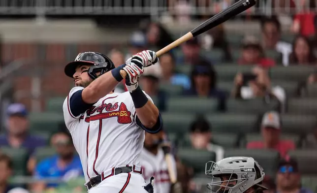 Atlanta Braves third baseman Austin Riley hits a three-run homer against the Boston Red Sox in the first inning of a baseball game, Sunday, May 17, 2026, in Atlanta. (AP Photo/Mike Stewart)