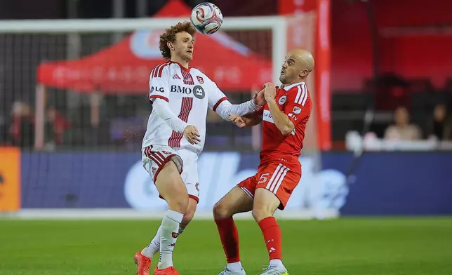 Toronto FC forward Josh Sargent, left, and Chicago Fire defender Andrew Gutman battle for the ball during the second half of an MLS soccer match Saturday, May 23, 2026, in Chicago. (AP Photo/Melissa Tamez)