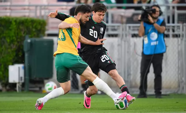 Mexico forward Mateo Chavez (20) dribbles as Australia defender Jacob Italiano, left, applies pressure during the first half of an international friendly soccer match Saturday, May 30, 2026, in Pasadena, Calif. (AP Photo/Kyusung Gong)