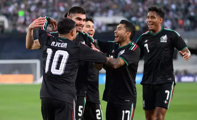Mexico players celebrate after a goal by Johan Vásquez, second from left, during the first half of an international friendly soccer match against Australia, Saturday, May 30, 2026, in Pasadena, Calif. (AP Photo/Kyusung Gong)