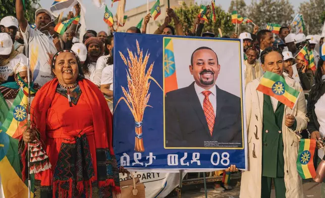 Supporters of Ethiopia's ruling party hold a large portrait of Prime Minister Abiy Ahmed at a rally ahead of the national elections in Addis Ababa, Ethiopia, Tuesday, May 26, 2026. (AP Photo/Amanuel Sileshi)