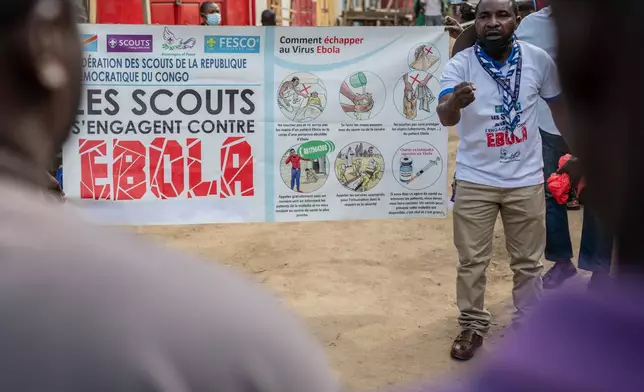 Francois Kasereka, a member of the Congo Scouts movement, speaks to people during a public sensitisation campaign amid the Ebola outbreak in Bunia, Congo, Saturday, May 23, 2026. (AP Photo/Moses Sawasawa)