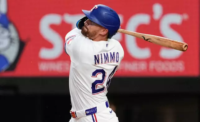 Texas Rangers' Brandon Nimmo follows through on triple in the fifth inning of a baseball game against the Arizona Diamondbacks Tuesday, May 12, 2026, in Arlington, Texas. (AP Photo/Tony Gutierrez)